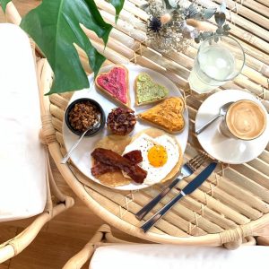 Plate of french homemade pastries with coffee and lemonade on wooden table for brunch at Mademoiselle Simone bordeaux france