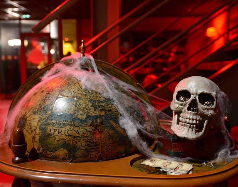 globe wrapped in spider web with skull halloween decorations escape game bordeaux france